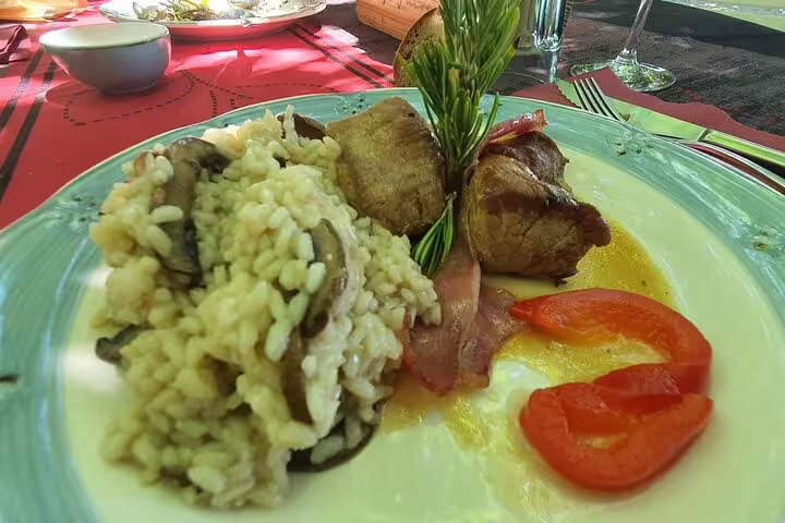 Delicious Portuguese meal with risotto and meat, part of the Douro Valley wine tour culinary experience.