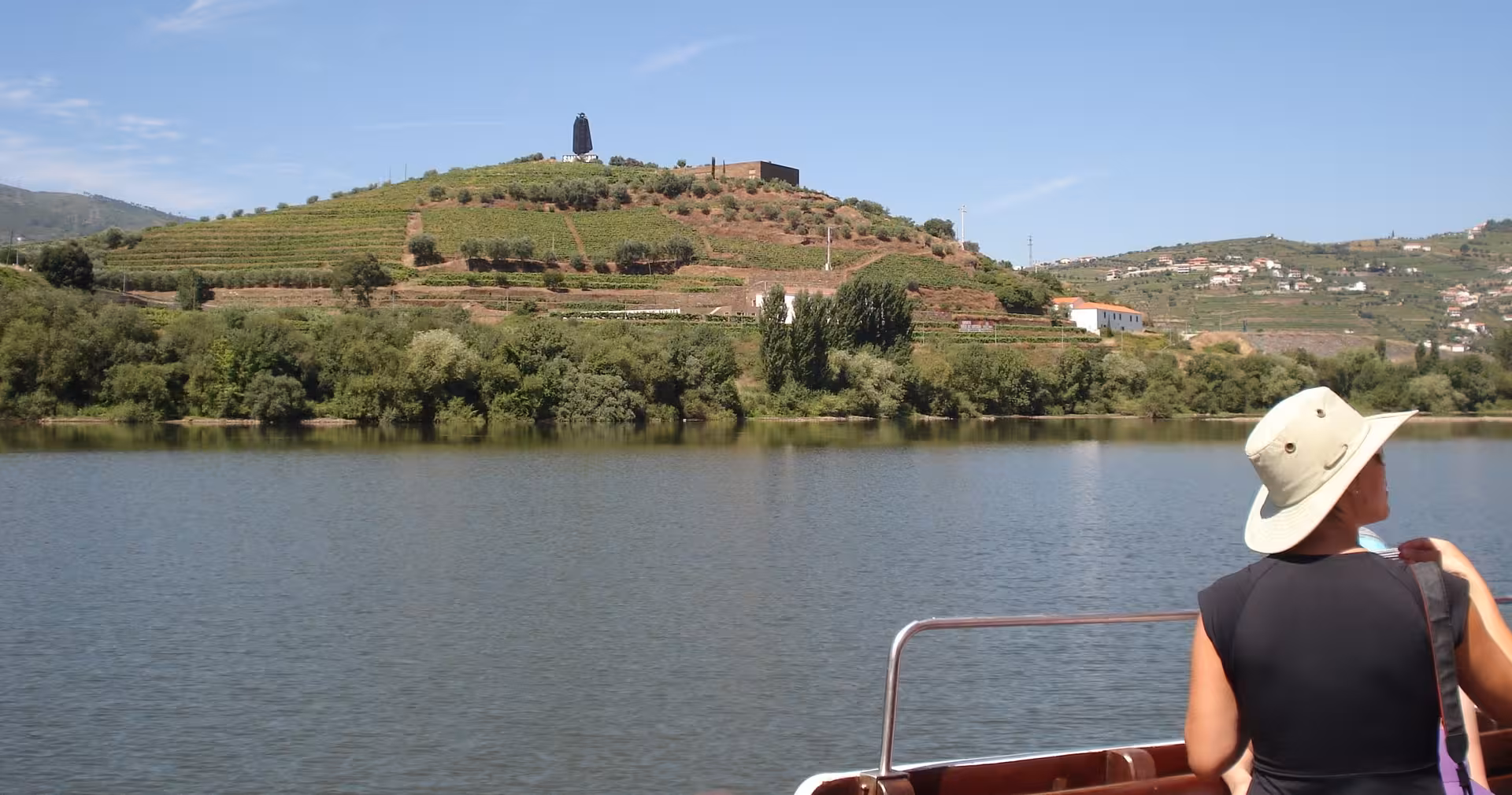 Douro River cruise view of terraced vineyards, seen from boat on Braga to Douro Valley small-group wine tour