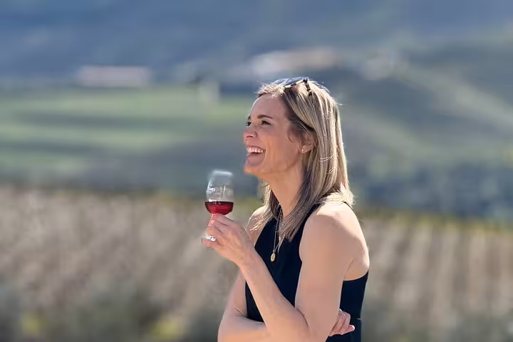 Woman tasting Douro wine in vineyard scenery during a private Douro Valley luxury wine tour