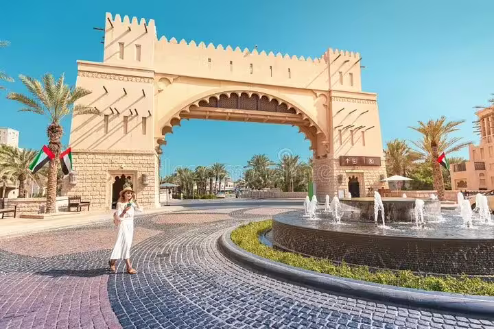 Woman exploring traditional Arabic architecture and fountains in Dubai on a private 4x4 city sightseeing tour.