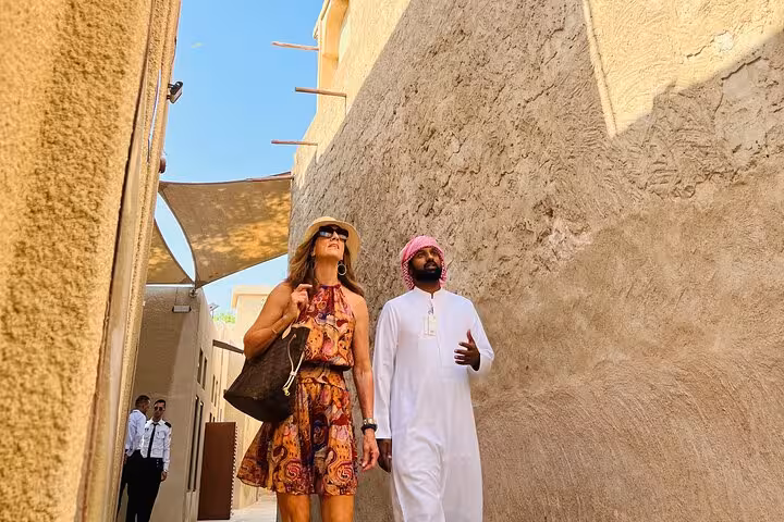 Tourists explore Al Fahidi historic district alley on Dubai city tour with Ain Dubai entrance included