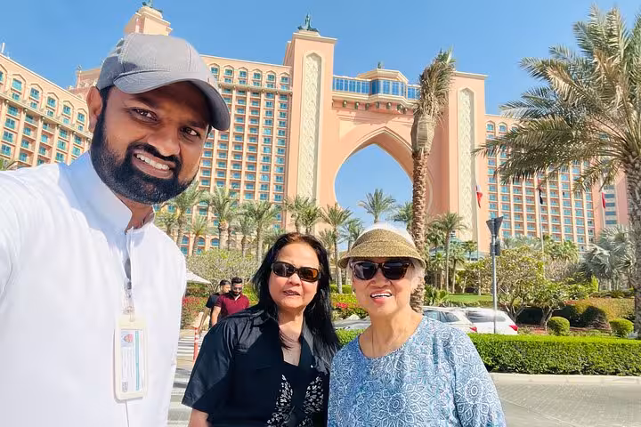 Tourists with guide at Atlantis The Palm Dubai on full-day city tour from Ras Al Khaimah, kids under 12 free