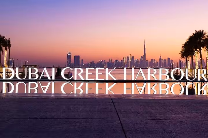 Dubai Creek Harbour sign at sunset with Dubai skyline views, ideal stop on Old Souk evening tour