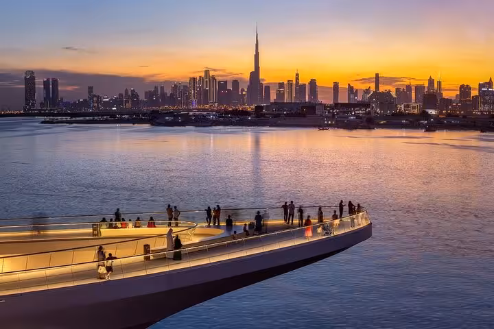 Sunset view from Dubai Creek Harbour promenade with Burj Khalifa skyline, part of Creek Mall tour