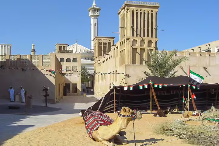 Explore traditional Dubai with a camel, historic architecture, and desert vibes on a magical day and night tour.