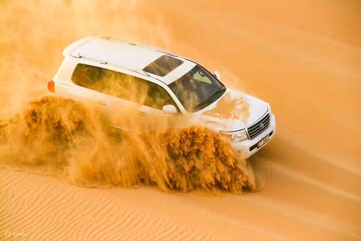 Dynamic 4x4 vehicle navigating through sandy dunes on a Dubai desert safari, highlighting thrilling off-road experiences.
