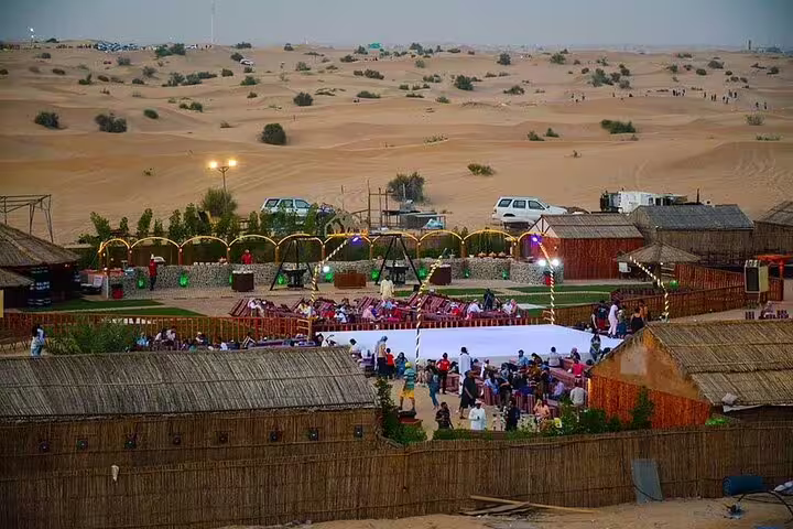 Guests gather for a lively evening at a desert camp with entertainment during a Dubai safari.