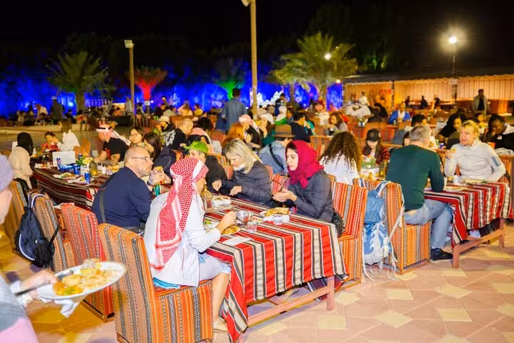 Dubai desert camp buffet dinner with traditional seating, night stop on multi day Dubai to Abu Dhabi tour