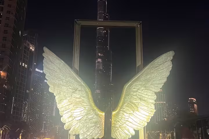 Dubai Frame glowing wings photo spot at night, ideal stop on Dubai Creek Mall fountains and Old Souk tour