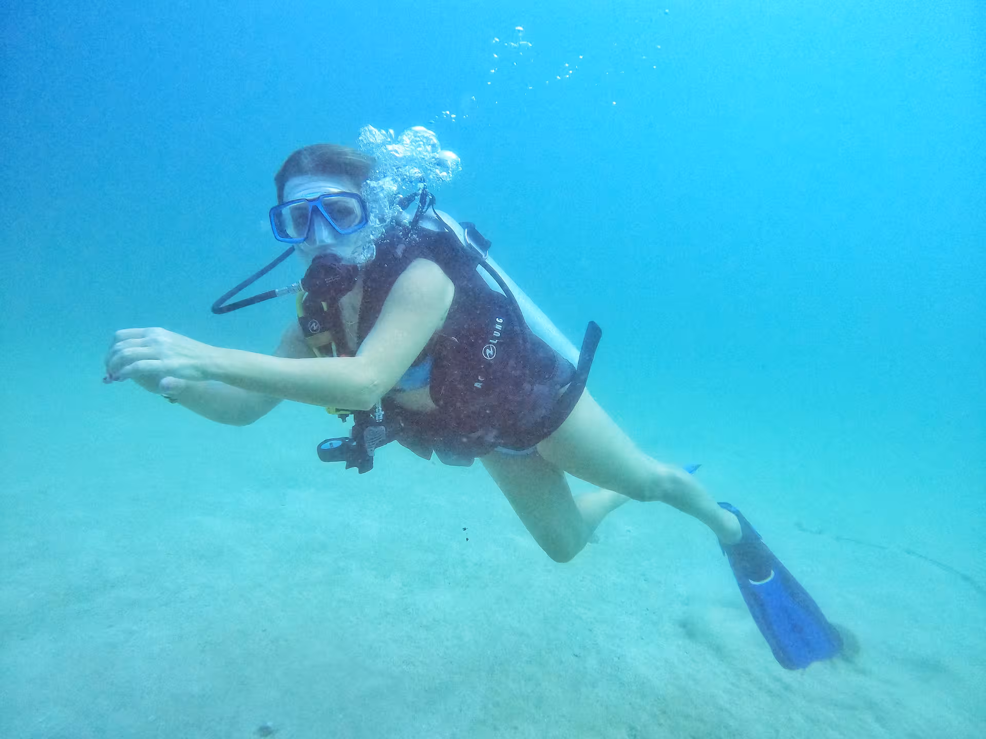 Diver explores clear waters off Fujairah, capturing the thrill of Dubai to Fujairah diving adventure.