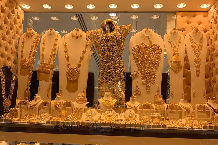 Dubai Gold Souk showcase of ornate 24K necklaces and bridal sets on Customizable AlSeef shopping tour