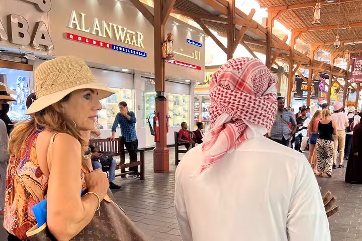 Tourists exploring Dubai Gold Souk market with local guide, a cultural stop on Dubai city tour with Ain Dubai