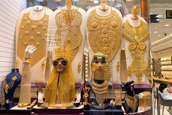 Luxurious gold jewelry display at Dubai's Gold Souk, highlighting intricate designs on the Magical Day & Night Tour.