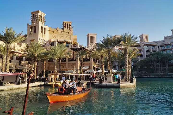Experience a scenic boat ride through Dubai's Madinat Jumeirah with stunning architecture on a 4x4 city tour.