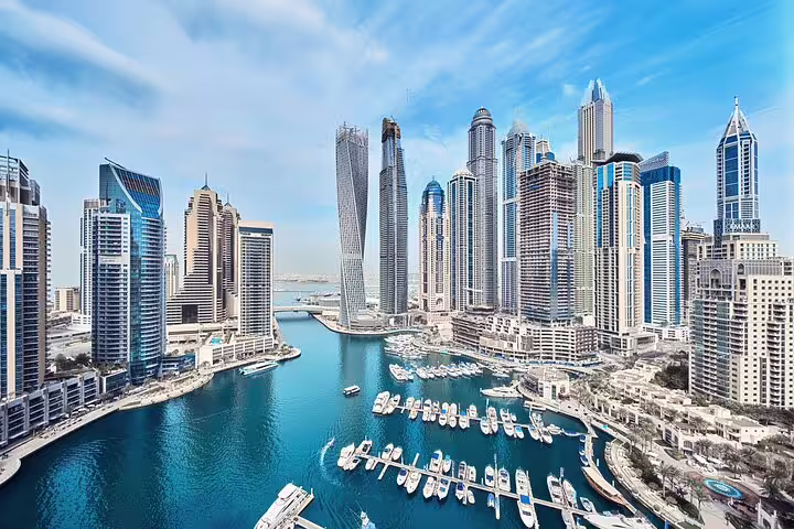 Stunning aerial view of Dubai Marina's skyscrapers and yachts, perfect for a 4x4 city sightseeing tour experience.