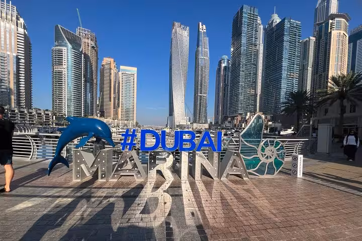 Dubai Marina skyline and #DubaiMarina sign stop on private Dubai city tour from Abu Dhabi with fountain show