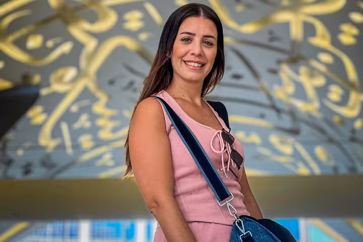 Woman in pink top smiles at Dubai Museum of the Future, capturing a Dubai Layover Instagram Private Videography Tour moment.