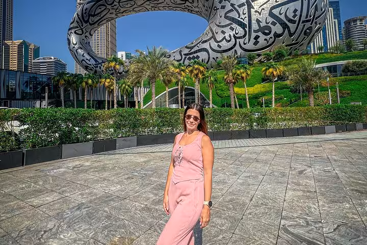 Woman in pink outfit at Dubai Museum of the Future, ideal for layover Instagram videography tour.