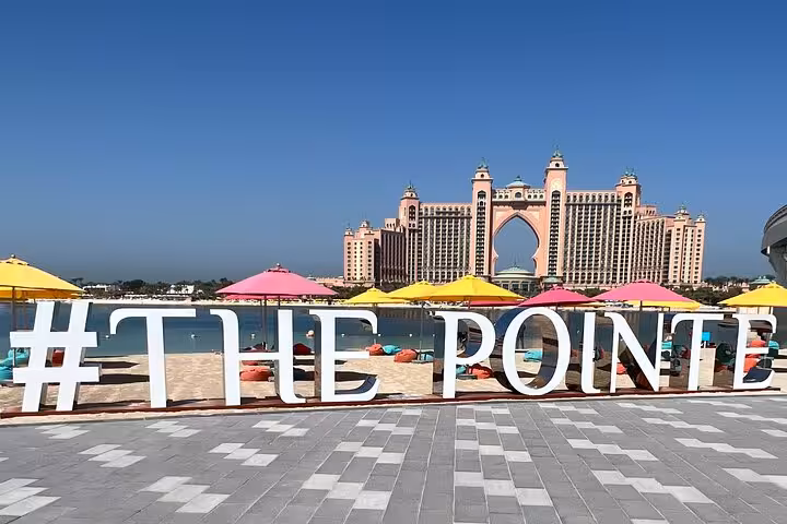 The Pointe waterfront with Atlantis The Palm view, a key photo stop on Dubai city tour from Abu Dhabi