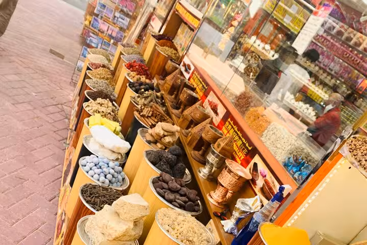 Spice and dry fruit market stall in Dubai souk, a stop on private Abu Dhabi to Dubai city tour with fountains show