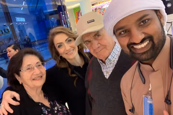 Happy travelers with Dubai tour guide during city pickup before Fujairah transfer, UAE private ride