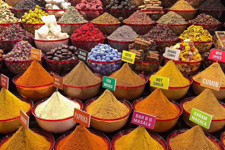 Vibrant array of spices at Dubai's spice market on a private full-day city tour.