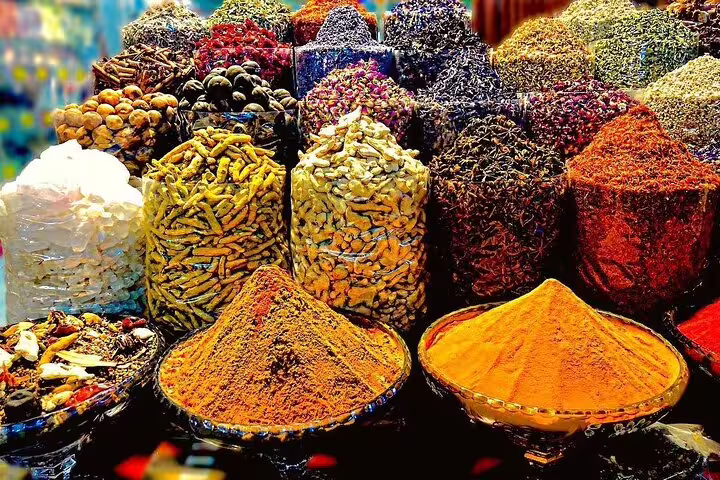 Vibrant display of various spices in a traditional Dubai market, highlighting the city's rich culinary culture.
