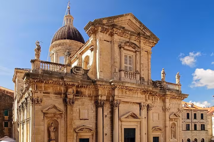 Baroque Dubrovnik Cathedral facade under blue sky, cultural stop on Dubrovnik to Zagreb multi-city tour