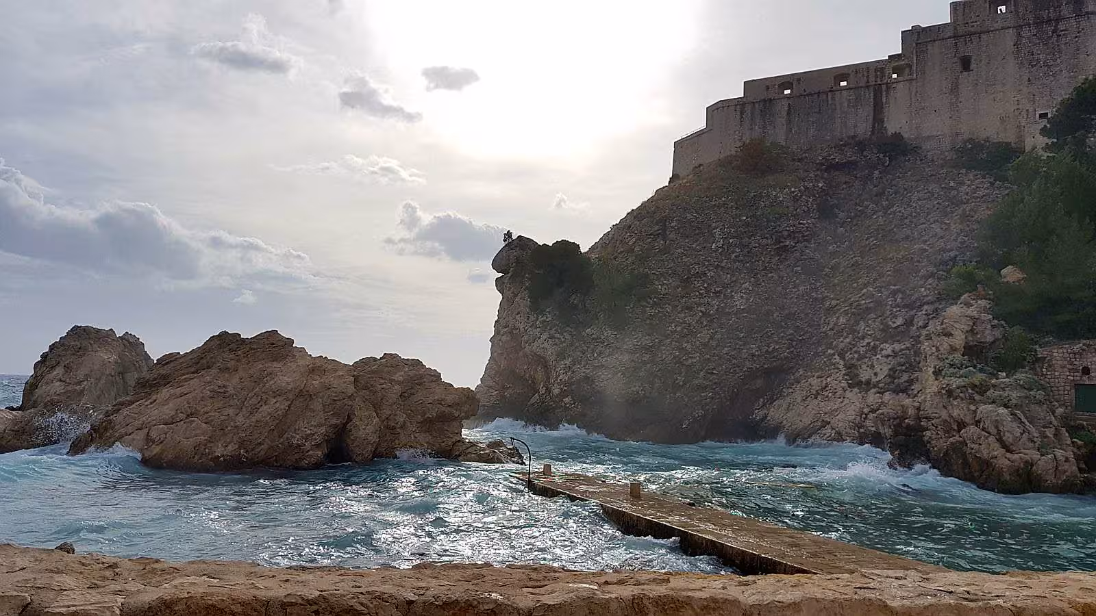 Rocky coastline below Dubrovnik city walls near Fort Lovrijenac, dramatic Adriatic views on city tour