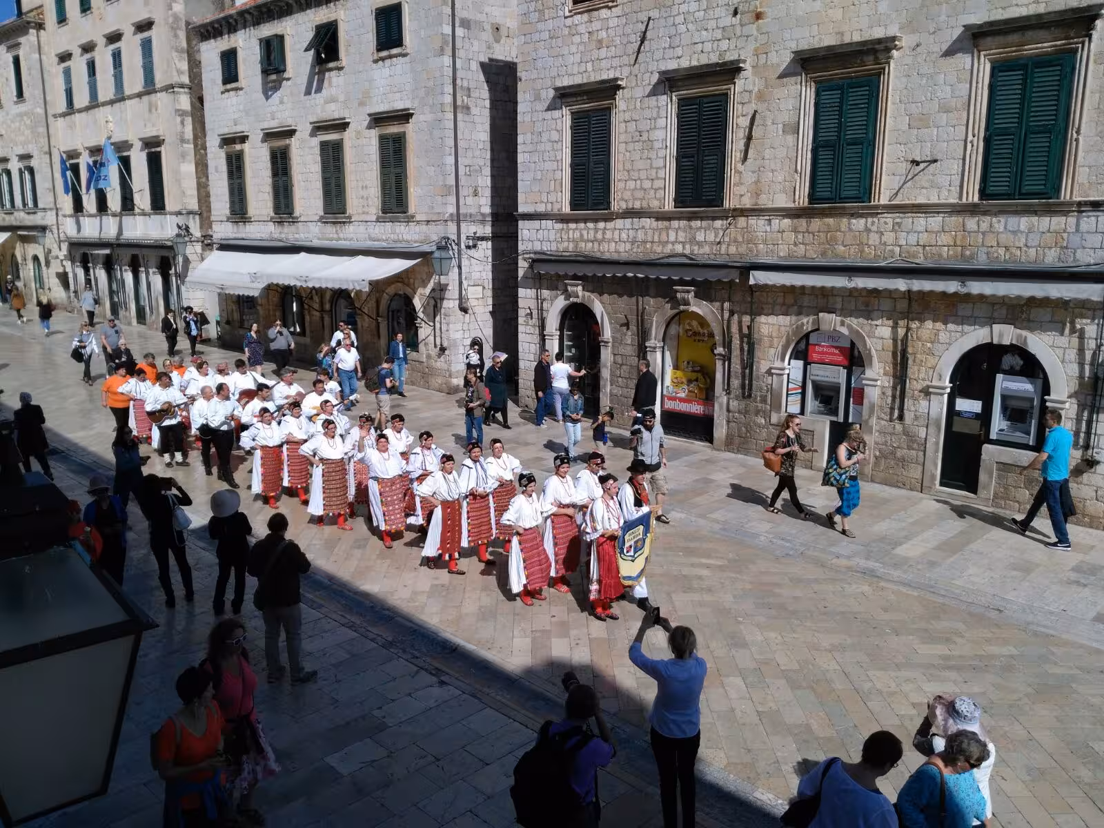 Traditional folk parade on Dubrovnik Stradun, cultural heritage stop on Dubrovnik history city tour