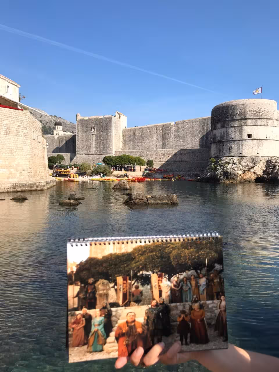 Dubrovnik Old Town harbor and fort walls with Game of Thrones scene overlay, on combo GOT & history walking tour