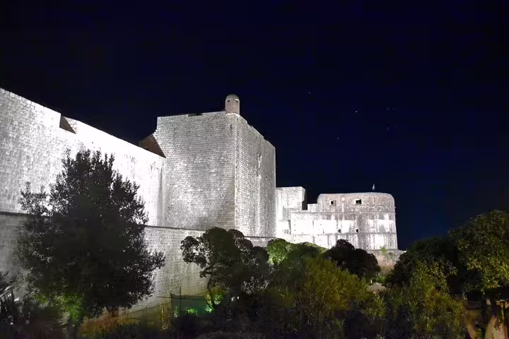 Illuminated Dubrovnik city walls at night, a highlight of the Dubrovnik By Night walking group tour
