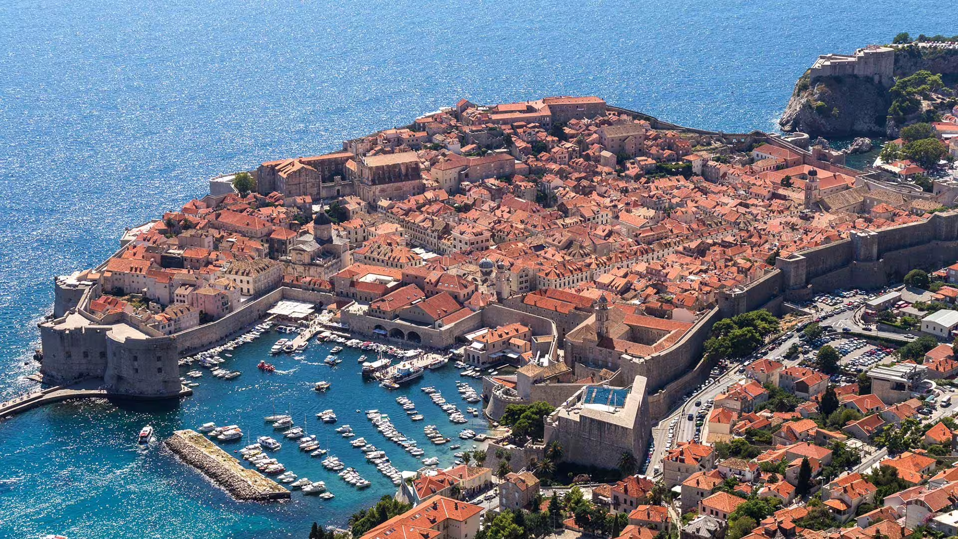 Aerial view of Dubrovnik Old Town walls and marina on the Adriatic Sea, featured stop on Scenic Panorama Drive