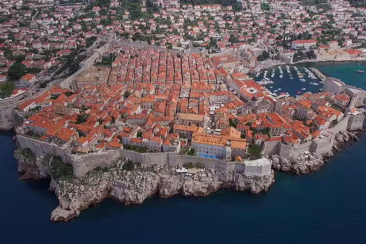 Aerial view of Dubrovnik Old Town and harbor, scenic stop on a Dubrovnik By Night walking group tour