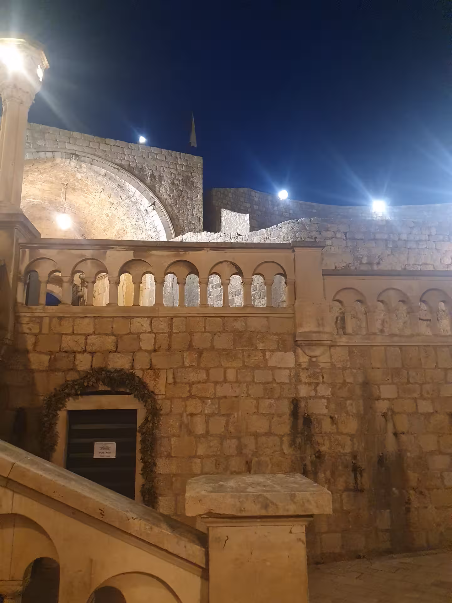 Dubrovnik Old Town at night with illuminated stone arches and city walls on the history by night tour