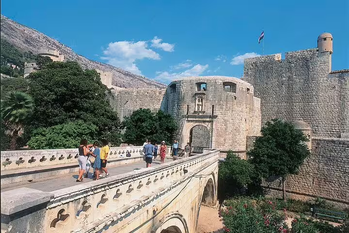 Visitors crossing the bridge to Pile Gate and Dubrovnik city walls on a private Dubrovnik Old Town tour