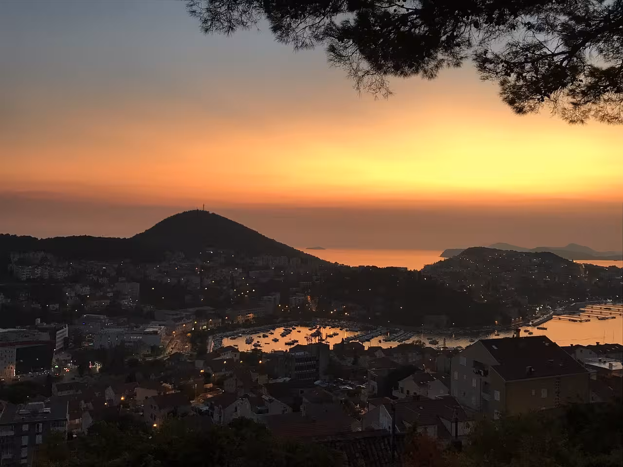 Golden Dubrovnik sunset panorama over Adriatic coast and marina, perfect for an exclusive boat cruise tour