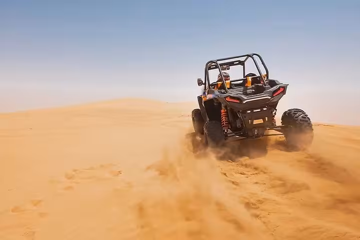 Off-road dune buggy speeding over sandy Sinai desert near Sharm El Sheikh, thrilling safari adventure ride