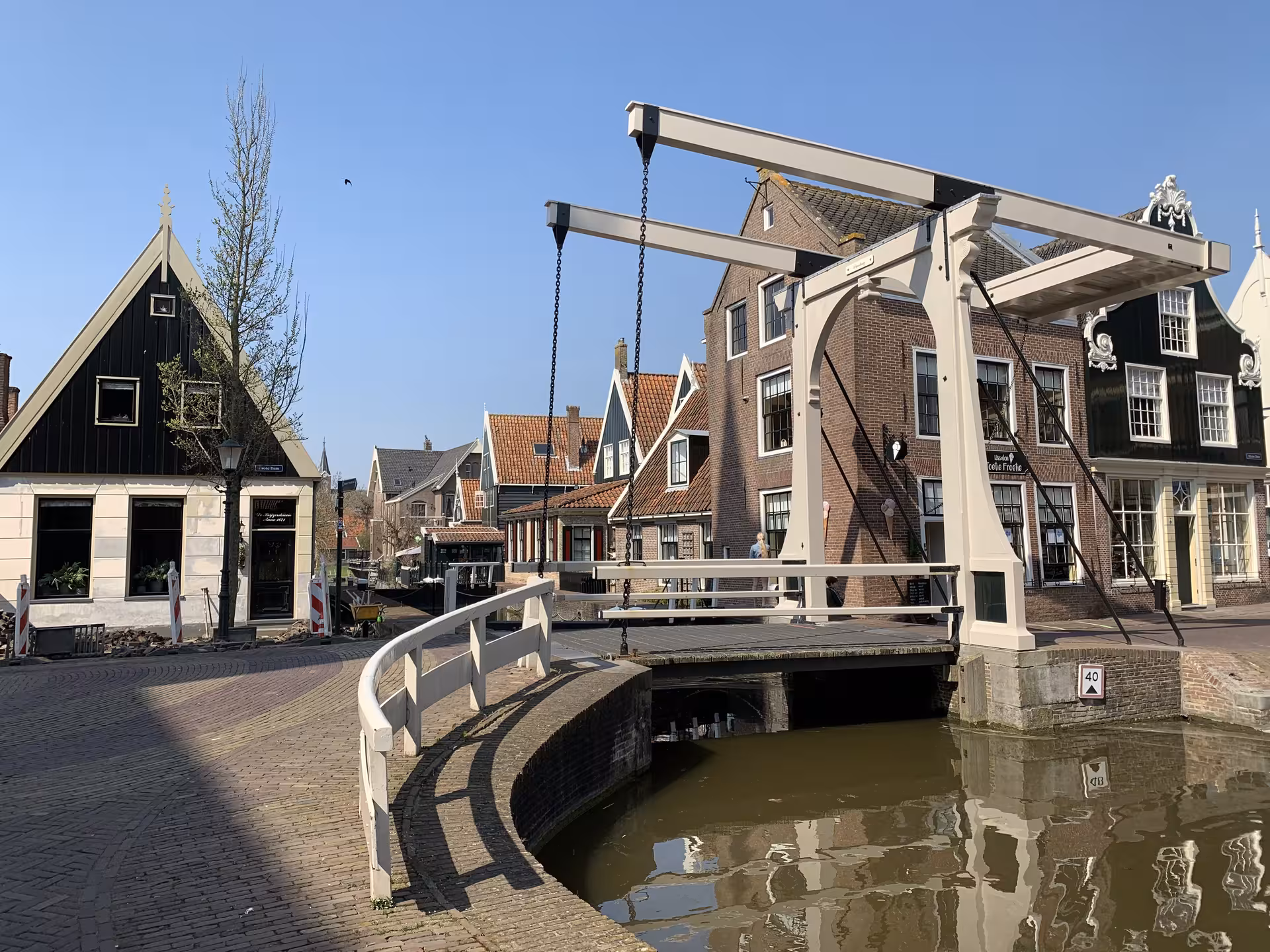 Historic Dutch canal drawbridge and gabled houses, charming village stop on private tour from Leiden and The Hague