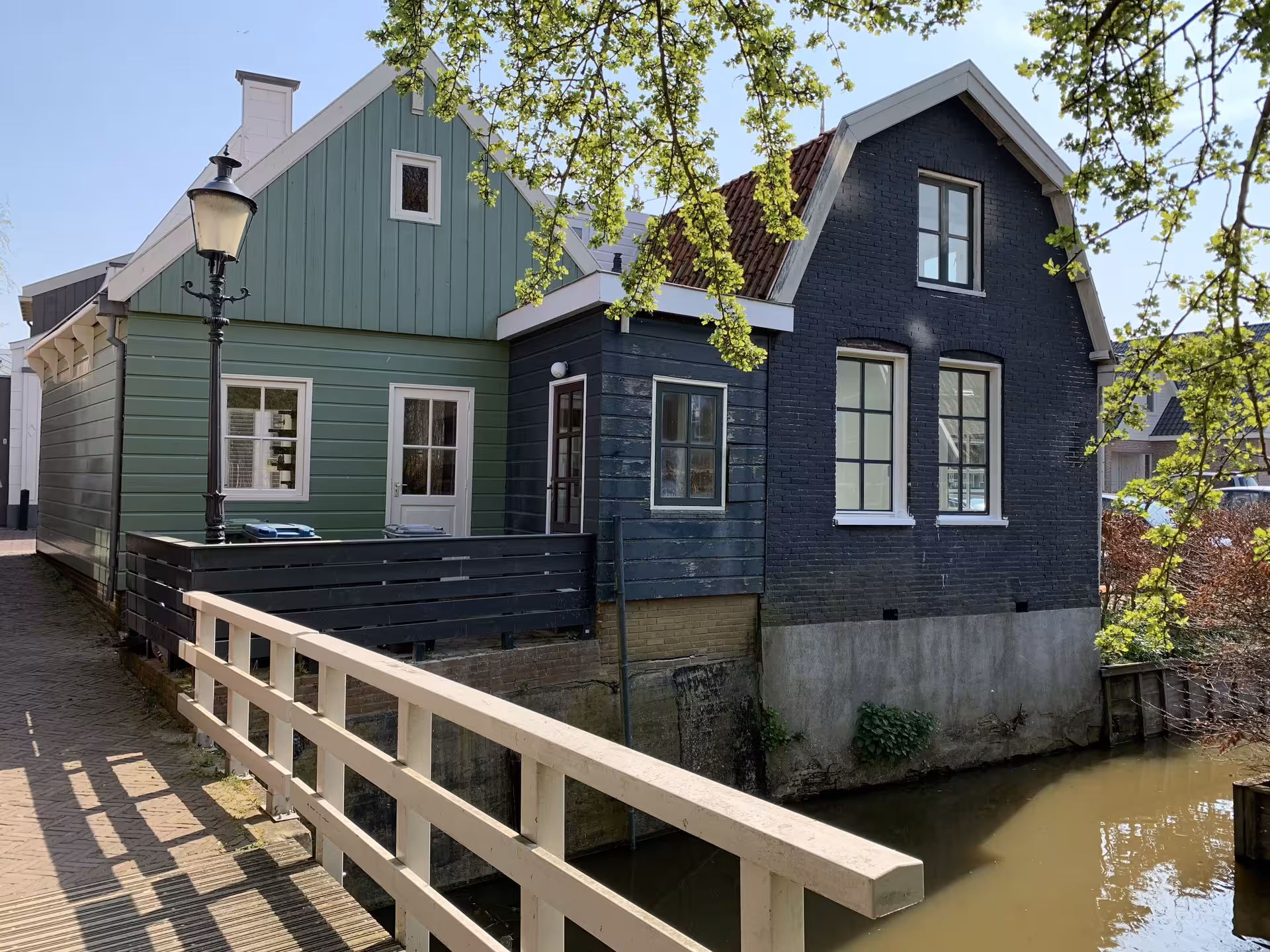 Historic Dutch canal house and footbridge in a quaint village, scenic stop on private tour from The Hague