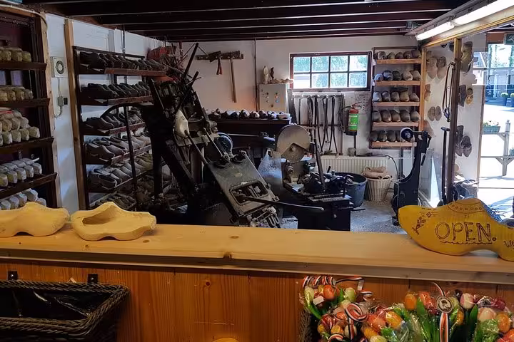 Traditional Dutch clog workshop near Amsterdam, wooden shoe making display on a city and countryside tour