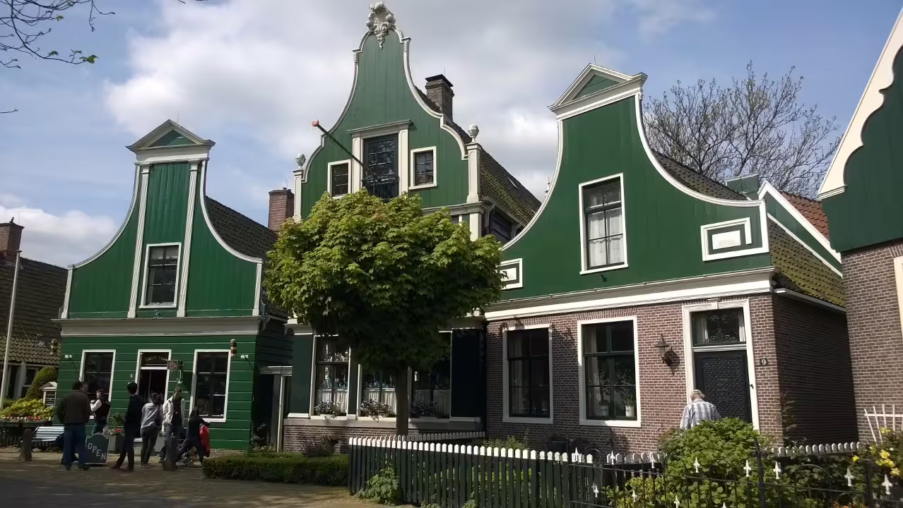 Traditional green Dutch houses in Zaanse Schans village on a private day tour from Amsterdam, Netherlands