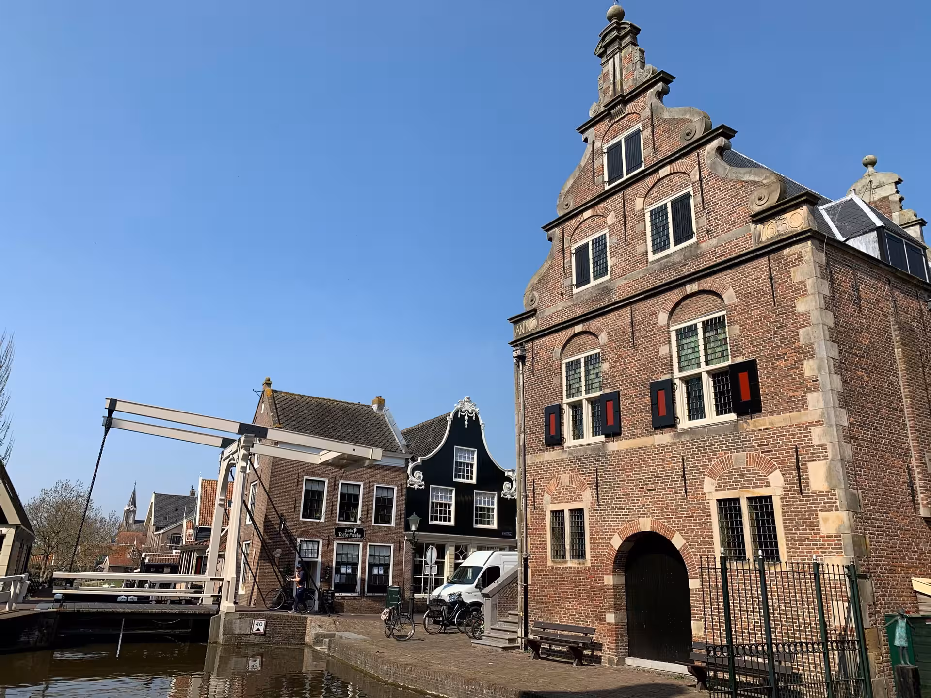 Brick gabled landmark by canal and drawbridge, Dutch heritage village sightseeing on private tour from Noordwijk
