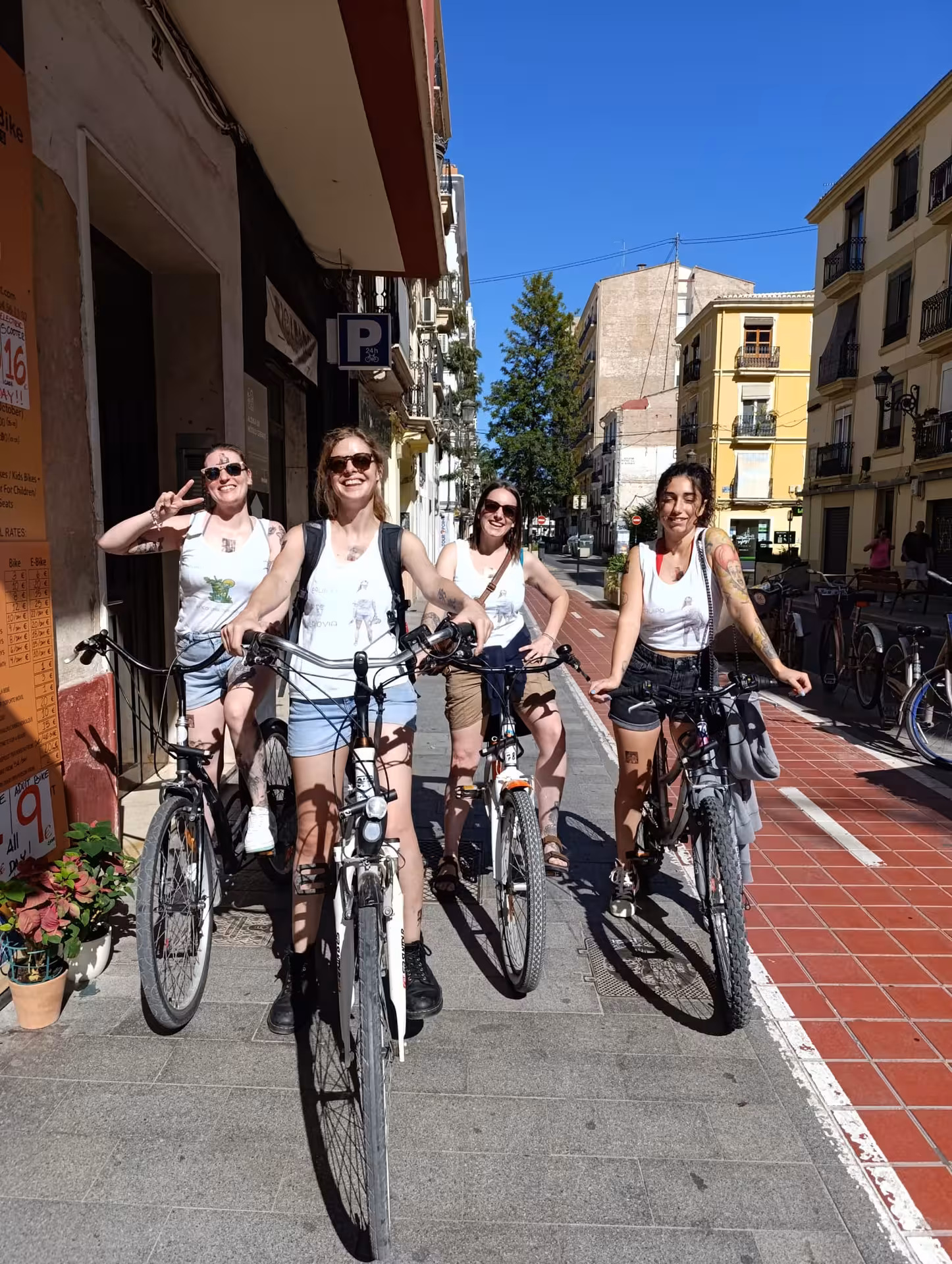 Friends posing with rented Dutch-style Omafiets city bikes on a sunny street, ideal for easy city cycling