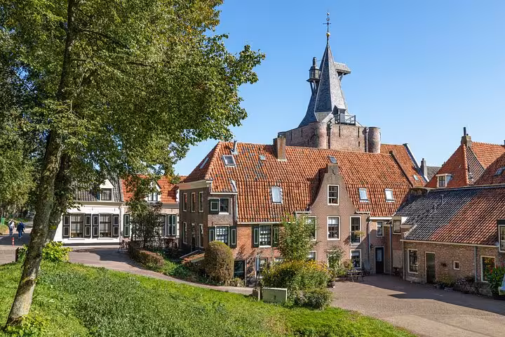 Historic Dutch village with red-tiled roofs and church tower on Discover The Netherlands tour from Amsterdam