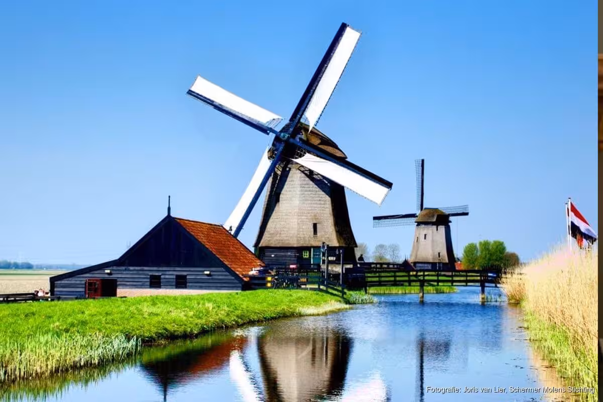 Classic Dutch windmills by dike and canal in the countryside, iconic windmill tour from The Hague or Leiden