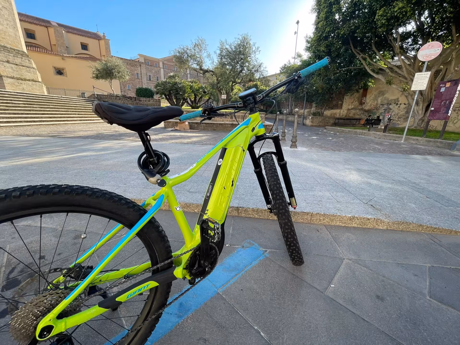 Parked e-bike in Oristano's scenic square, perfect for a relaxing Sardinian holiday adventure.