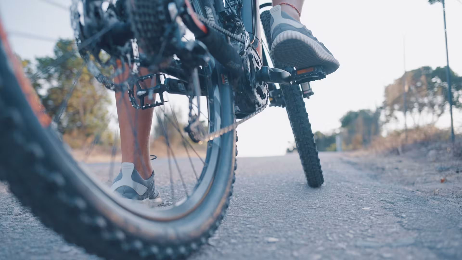 Close-up view of a person riding an e-bike on a paved path, capturing the thrill of cycling in Sardinia.