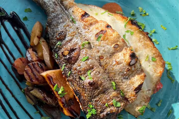 Cyclist enjoying a scenic e-bike ride on a wooden path through lush greenery in Cascais and Sintra backroads.