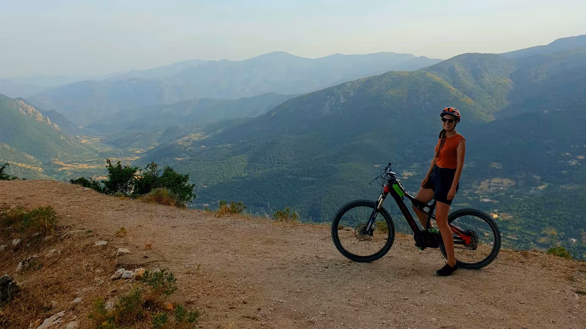 Cyclist enjoys panoramic mountain views on an e-bike tour in Supramonte, Urzulei, perfect for nature lovers.